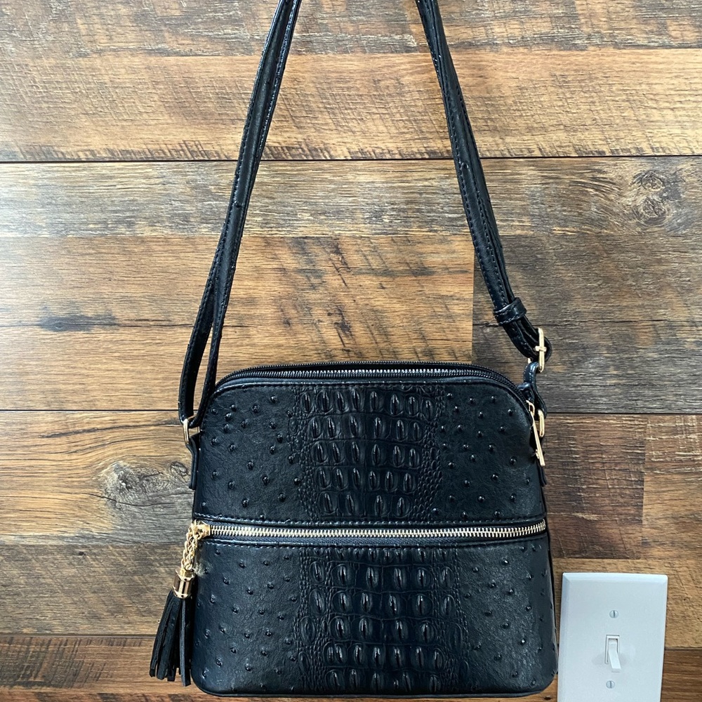 Black purse with adjustable shoulder strap
